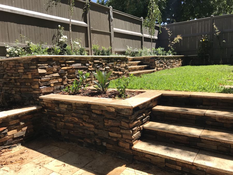 stacked stone retaining wall and steps